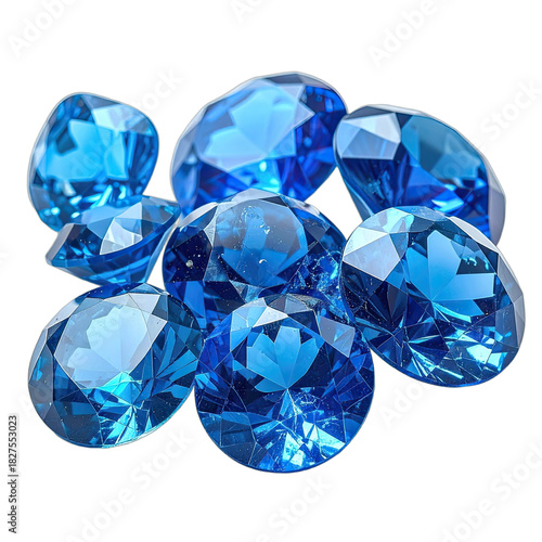 A collection of brilliant, faceted, deep blue gemstones resting on a stark black background.