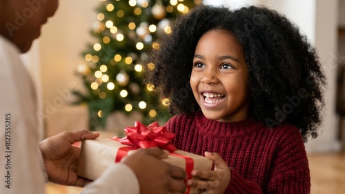 A child joyfully receiving a Christmas gift with a big red bow in front of a Christmas tree, ideal for holiday gift-giving promotions, family-themed marketing, or festive advertisements