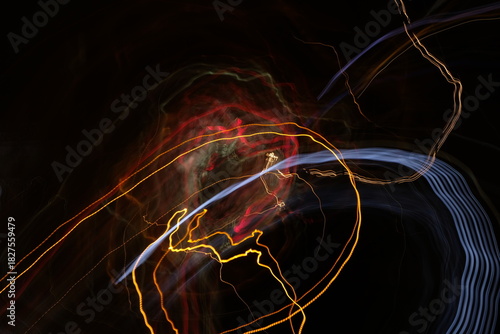 Cosmic Trails: Dark Abstract with Swirling Red and Gold Light