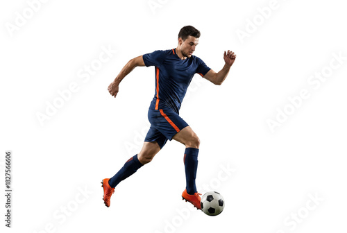 Male soccer player dribbling ball in mid stride on isolated black background, athletic action and competitive sports concept for training, fitness and team game promotion
