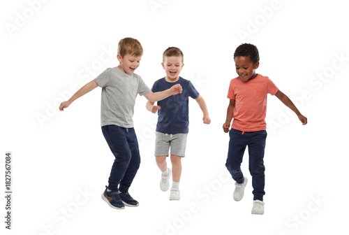 Three young boys playing soccer indoors on a white background, joyful childhood fitness and teamwork with active kids kicking ball in casual sportswear for school and recreation themes