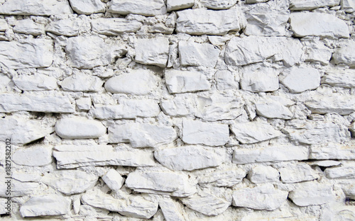 A detailed white stone wall texture made of natural rough rocks, perfect for backgrounds, architectural design, 3D modeling, graphic overlays, construction themes, and building material presentations.