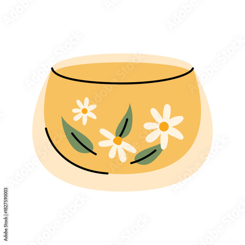 Transparent glass cup with warm chamomile tea and floral details for cozy drink moments