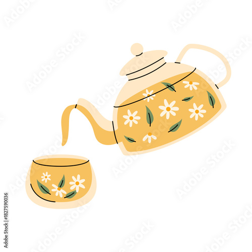 Transparent glass teapot with chamomile tea and matching cup in warm cozy floral style