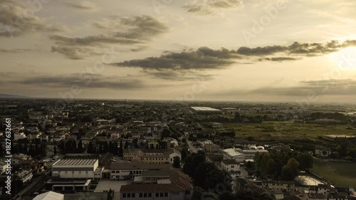 Drone flying above cittadella italy at sunset with a cloudy sky