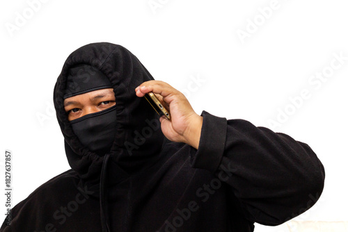 Man in black hoodie and mask talking on a mobile phone