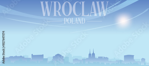 Blue panoramic poster of the city skyline with misty background buildings and clouds of WROCLAW, POLAND