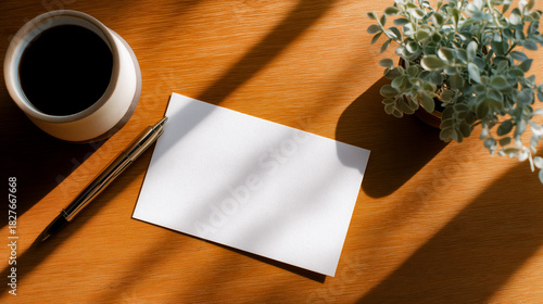 Flat lay shot of workspace desk with white file or card for template mockup. Copy space for text or logo.