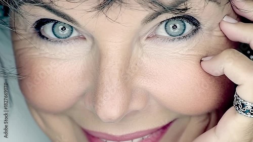 Close-up of a Womans Face with Expressive Blue Eyes and a Gentle Smile.