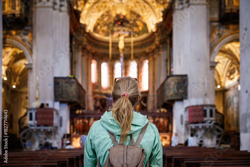 Woman visitor admiring church interiors and traditional italian christian architecture while sightseeing in Italy