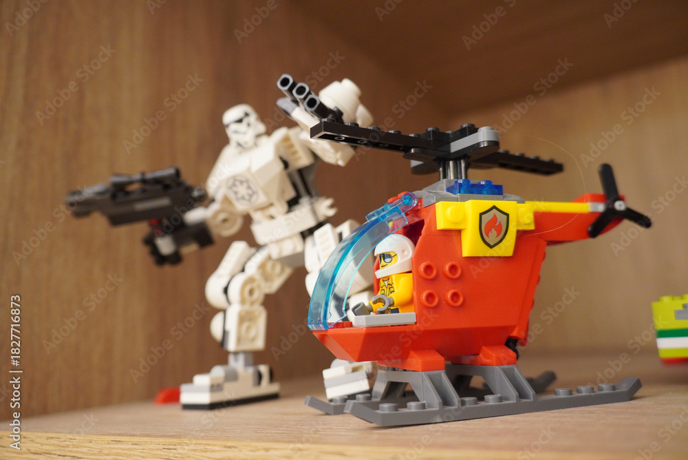 Naklejka premium Lego Star Wars Stormtrooper mech and fire rescue helicopter on a shelf