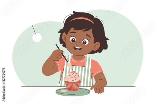 A cheerful girl decorates a cupcake with a brush.  She smiles wearing an apron against a soft green background