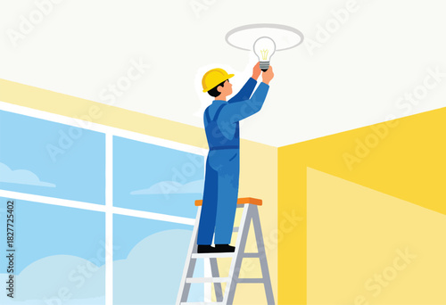 A construction worker in blue overalls and yellow hardhat replaces a light bulb while standing on a ladder