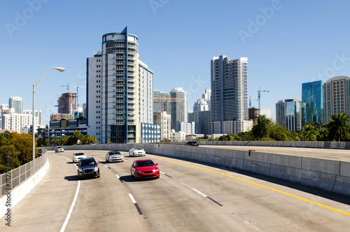 Wallpaper Mural Highway to North Miami with cars driving, modern skyscrapers rising behind under a bright blue sky. Torontodigital.ca