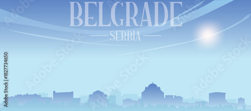 Blue panoramic poster of the city skyline with misty background buildings and clouds of BELGRADE, SERBIA