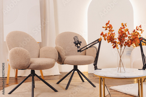 Relaxed podcast setup with stylish chairs and microphones in a cozy space for engaging conversations