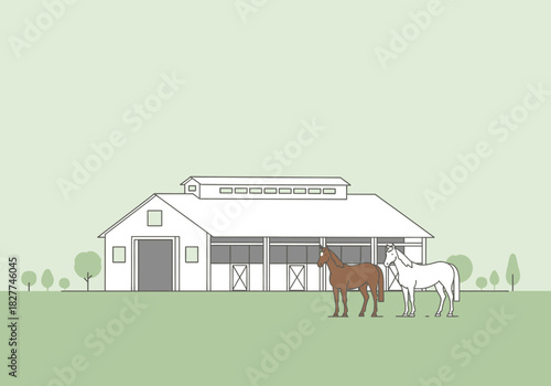 Two horses standing in front of a barn on a green field.