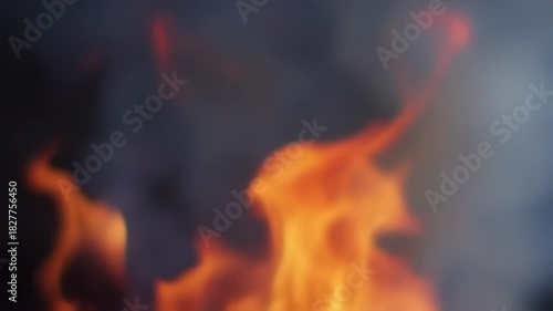 Close up of vibrant orange flames dancing against a dark background.