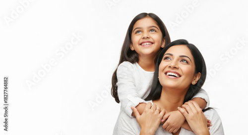 Joyful Indian mother and child smiling, looking upwards