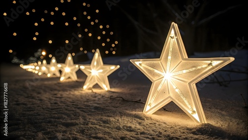 Illuminated star shaped outdoor decorations line a snowy path creating a magical winter wonderland ambiance at night