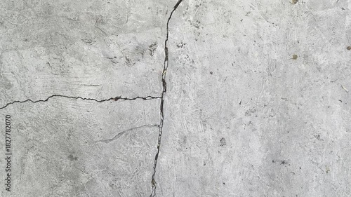 Zoom out and Top view of cracked old textured wall surface damage. It may be caused by an earthquake.