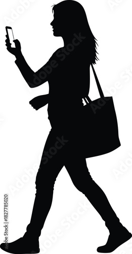 Silhouette of a woman walking and checking her phone