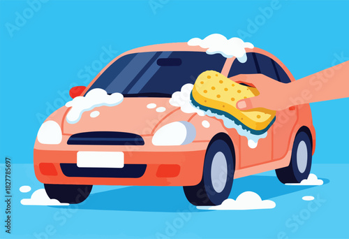 A peach-colored car is being washed with a sponge and soapy bubbles. A hand holds the yellow sponge