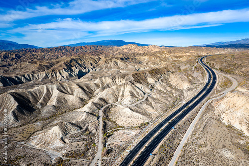 Cutting Through the Arid Landscape: Aerial View of the Highway Crossing the Desolate Tabernas Desert in Southern Spain	