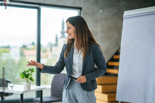 Businesswoman talking during corporate presentation in modern office