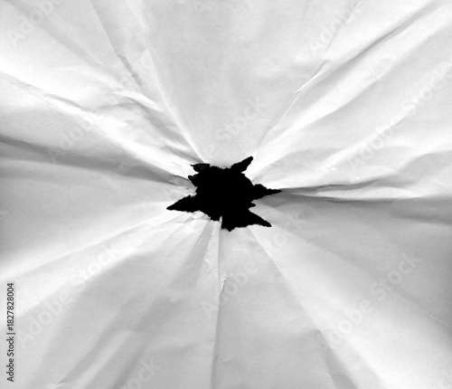 Black hole in crumpled paper with torn edges