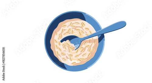 Healthy and hearty bowl of oatmeal or porridge with a spoon ready for breakfast presented from a top-down view.