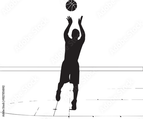 Silhouette of a basketball player shooting a ball during a game on a court