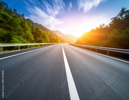 A scenic highway leading into a radiant sunset, framed by vibrant green trees