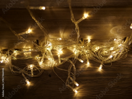 Warm Glow of Twinkling Fairy Lights on a Wooden Surface at Night
