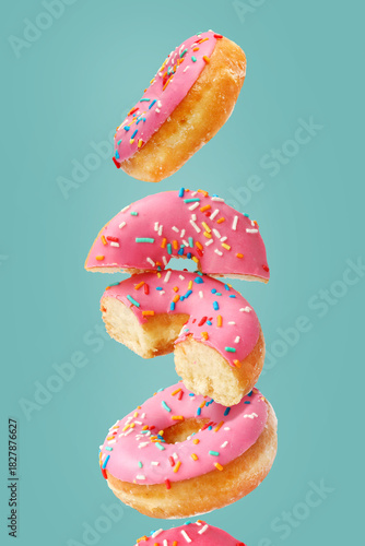 Creative concept of donuts on the turquoise background. Desserts, bakery pastries.