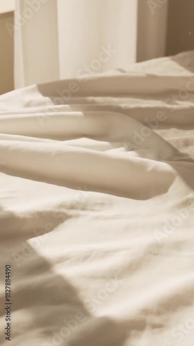 Soft White Linen Sheet Flowing in Gentle Breeze with Sunlight and Sheer Curtain