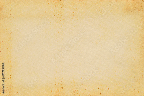 A sheet of old beige spotted paper texture as background
