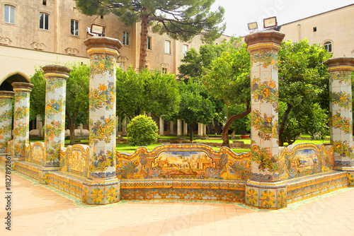 View of the colorful tiled columns of the cloister of Santa Chiara in Naples, Campania, Italy.