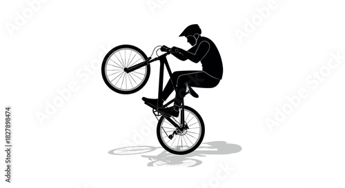 Cyclist performing wheelie silhouette on mountain bike