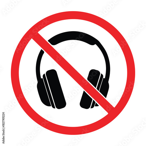 Prohibition symbol overlaying black silhouette of over ear headphones indicating no listening devices allowed