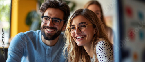 A happy couple wearing glasses and smiling at the camera in a home setting can serve as an atmospheric backdrop for advertising family values or friendships.