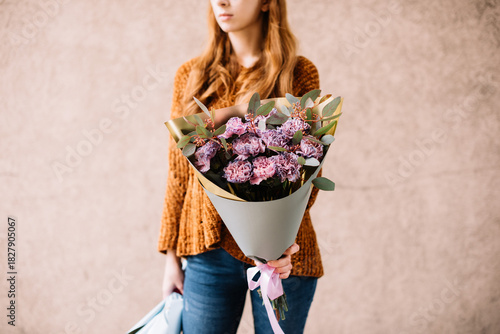 Wallpaper Mural Very nice young woman holding big and beautiful mono bouquet of fresh purple carnation flowers and eucalyptus Torontodigital.ca