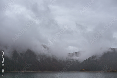 Thick valley fog wrapping mountain silhouettes