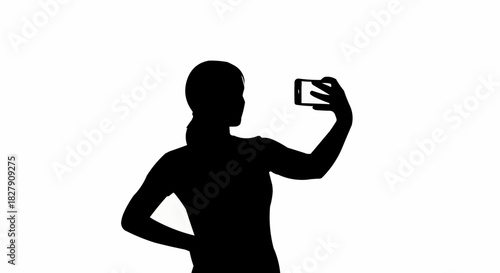 Silhouette of a woman taking a selfie with her smartphone.