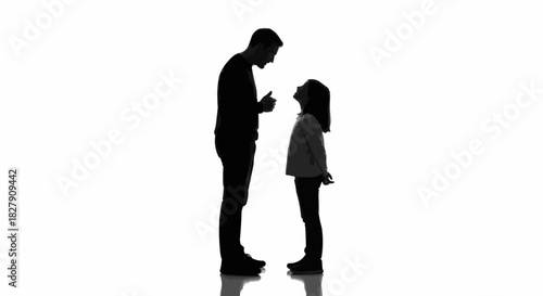 Silhouette of a father having a serious conversation with his daughter.