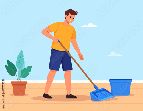A man in a yellow shirt sweeps a wooden floor with a blue dustpan and broom, near a potted plant and a blue bucket.