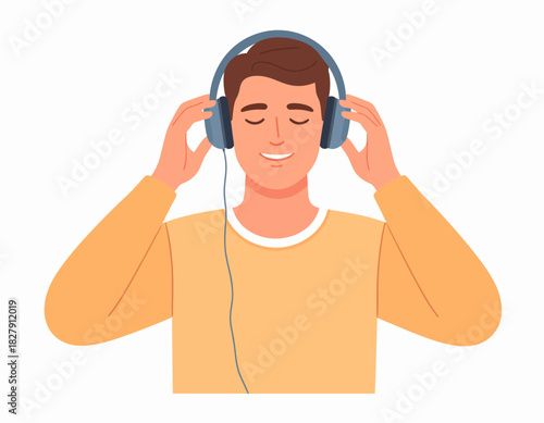 Man with closed eyes enjoys music through blue headphones, holding the earcups, wearing a yellow shirt.