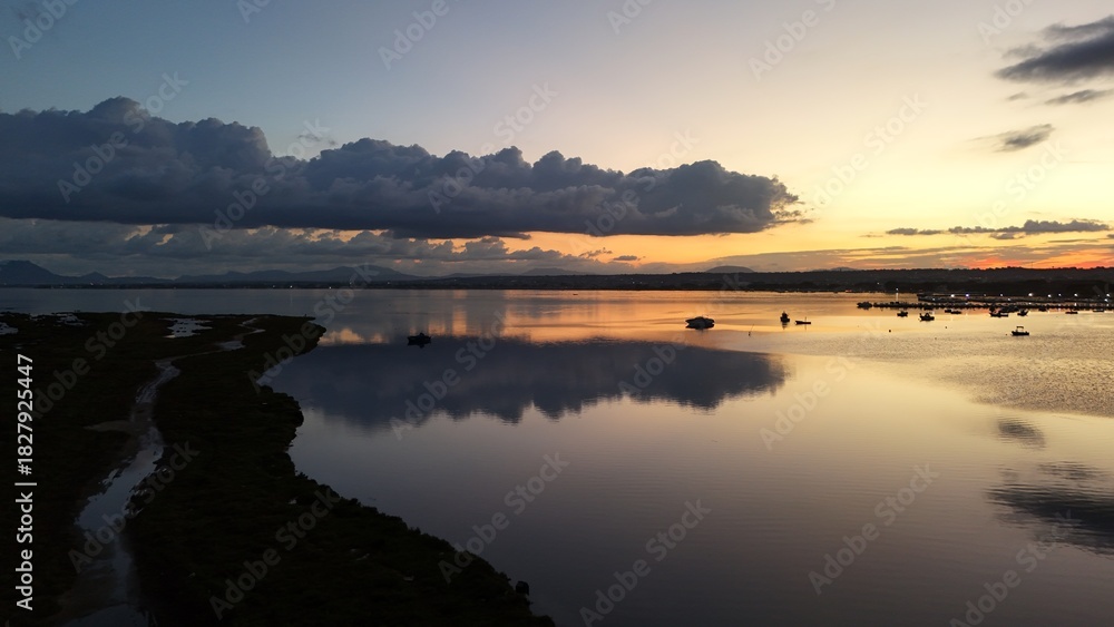 Fototapeta premium Insanely beautiful drone photography of a scenic sunrise, early in the morning, by the salt marshes in Marsala, Sicily, during a lovely morning. 
