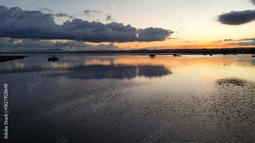 Fototapeta Naklejka Na Ścianę i Meble -  Insanely beautiful drone photography of a scenic sunrise, early in the morning, by the salt marshes in Marsala, Sicily, during a lovely morning.	