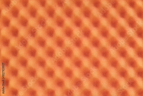 Orange colored egg crate foam sheet packing material dimples background texture.